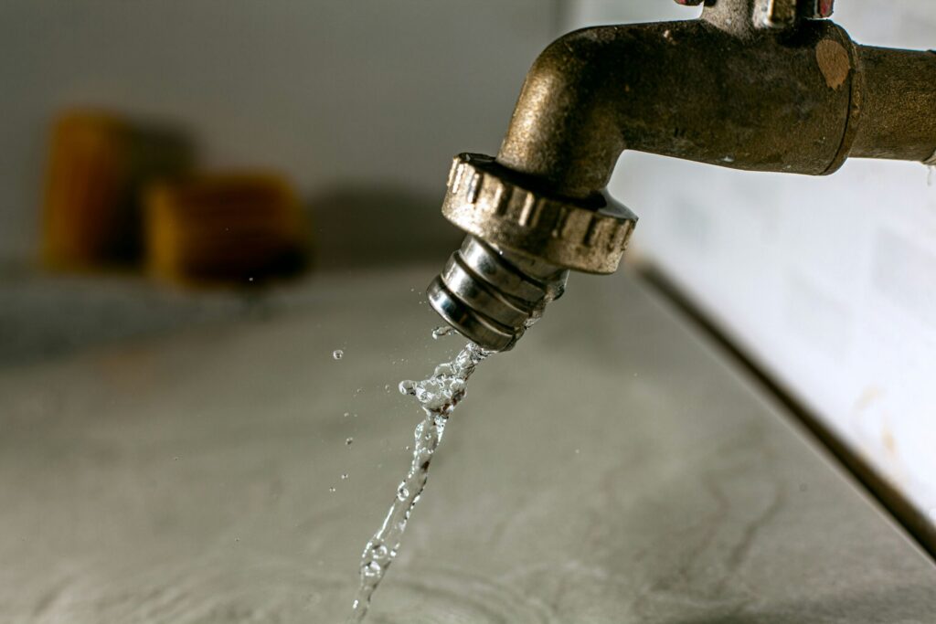 Water dripping from a faucet - Crest Plumbing